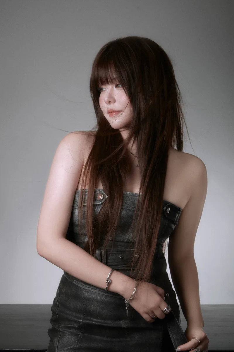 Studio portrait of Mayumi in a black leather dress
